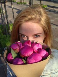 Close-up portrait of woman with pink flowers