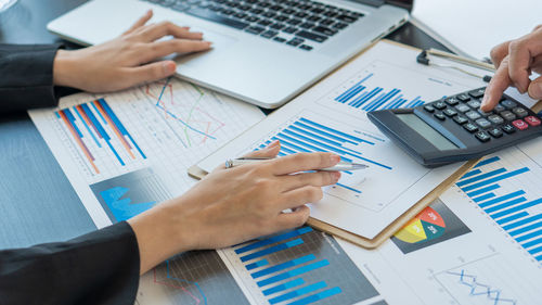 Cropped hands of business person working in office