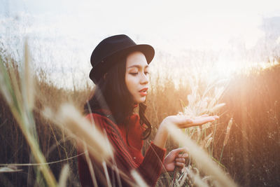 Young woman in hat on field