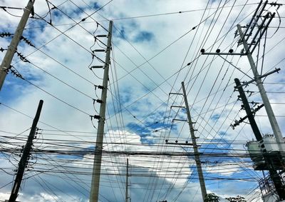 Low angle view of electricity pylon against sky