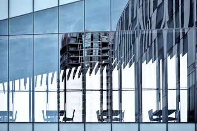 Low angle view of glass building against sky