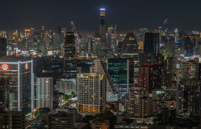 Aerial view of city lit up at night