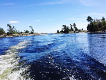 Scenic view of sea against blue sky