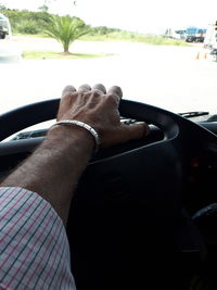 Close-up of human hand holding car