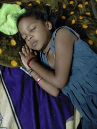 High angle view of baby sleeping on bed