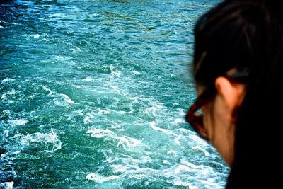 Cropped image of woman in front of sea