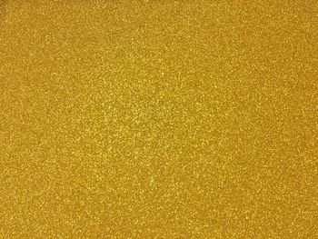 Full frame shot of golden glitter