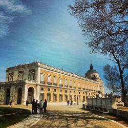 Tourists against cloudy sky