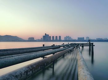 View of city at waterfront during sunset