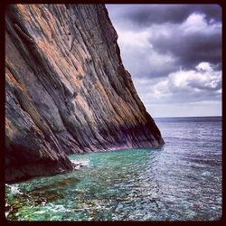 Scenic view of sea against cloudy sky