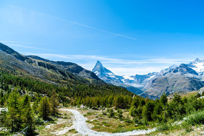 Scenic view of mountains against blue sky