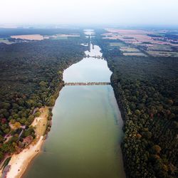 Aerial view of river in front of city against sky