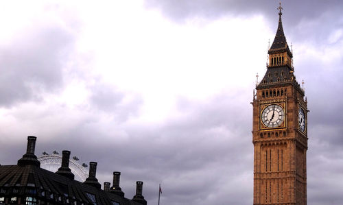 Low angle view of clock tower amidst buildings in city