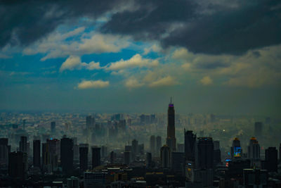 Cityscape against cloudy sky