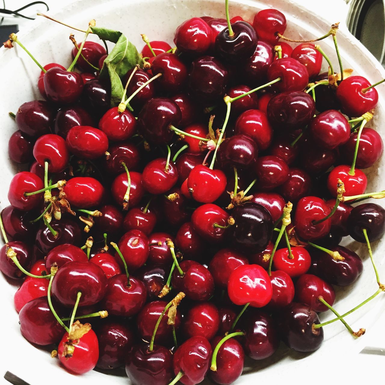 red, food and drink, food, indoors, freshness, fruit, healthy eating, high angle view, still life, large group of objects, close-up, strawberry, cherry, no people, table, bowl, abundance, berry fruit, ripe, directly above