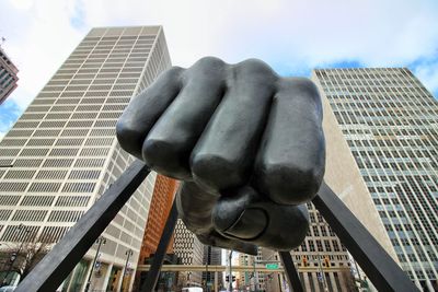 Low angle view of statue in city against sky