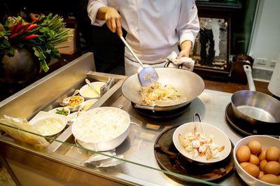 Midsection of chef preparing food in kitchen