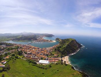 High angle view of sea and buildings against sky