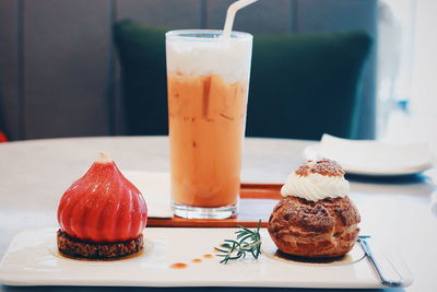 Close-up of dessert by drink on table