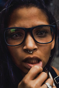 Close-up portrait of woman holding lip