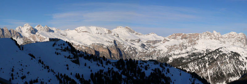 Scenic view of snowcapped mountains against blue sky