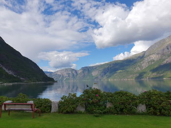 Reflection of the sky and mountains in the blue water of the fjord - eidfjord 