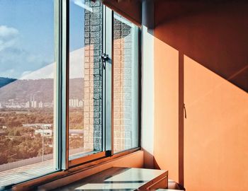 Modern building against sky seen through window