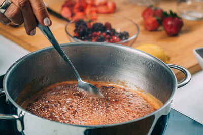 Fruit canning preservation. woman cooking fruits and making homemade jam.