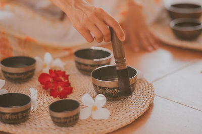 Female hands play meditation on tibetan bowls