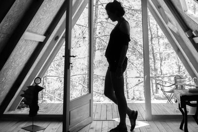 Portrait of woman against the sun in front of the door