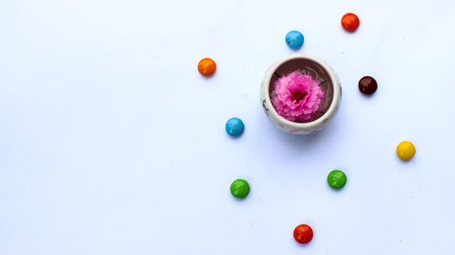 High angle view of multi colored candies against white background