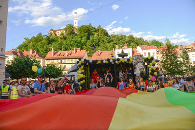 Crowd in city against sky