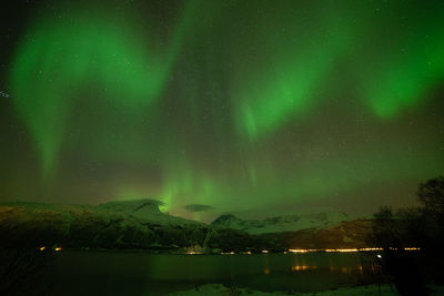 Scenic view of lake against sky at night