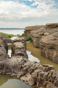 Rocks on beach against sky