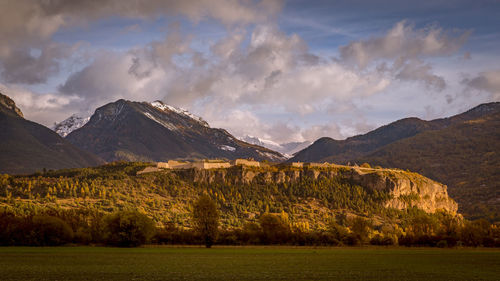 Scenic view of landscape and mountains against sky