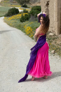 Woman performing belly oriental dancing wearing coloured costume. dancing outdoors