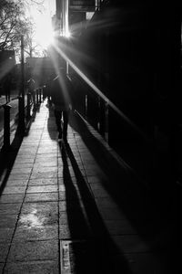 Silhouette of man walking on road