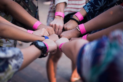 Cropped image of people clenching fists