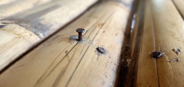 High angle view of old wooden plank on table