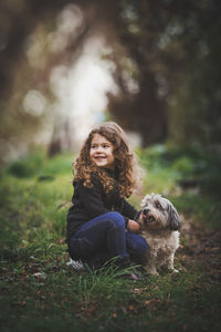 Portrait of a dog sitting on field