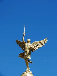 Low angle view of statue against clear blue sky