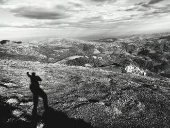 Man standing on mountain against sky