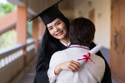 Portrait of a smiling young woman holding umbrella