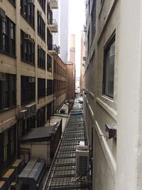 Walkway amidst buildings in city