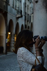 Rear view of woman photographing