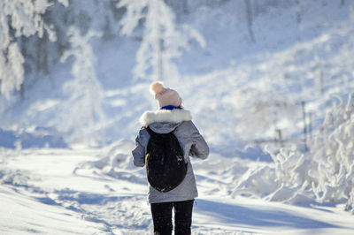 Man standing on snow covered land