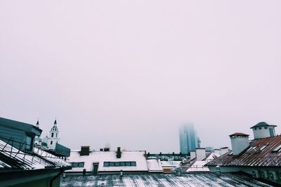 High section of buildings in city against clear sky