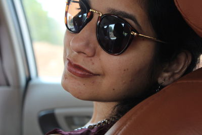 Close-up portrait of woman wearing sunglasses