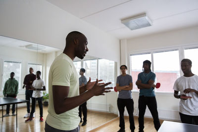 Instructor looking at students during training session in games room