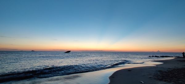 Scenic view of sea against clear sky during sunset